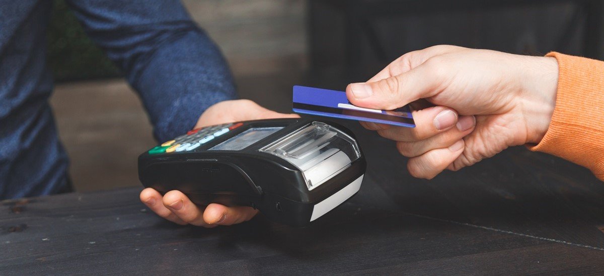 Close up of someone paying by card on a contactless reader